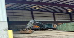 Excavator inside Woodland Waste transfer station building